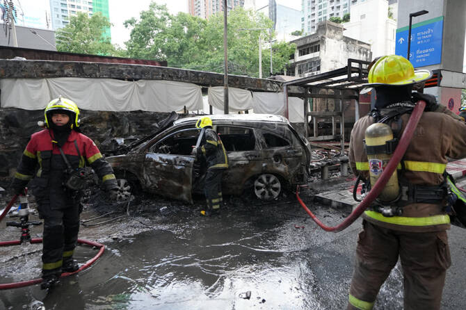 A cargo train hits a public bus at a Bangkok rail crossing, killing at least 8