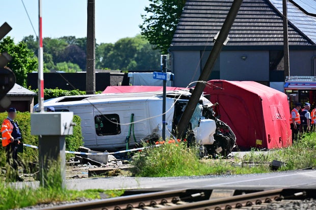 Train crashes into school minibus in Belgium, with unconfirmed reports of fatalities